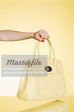 Woman holding yellow handbag