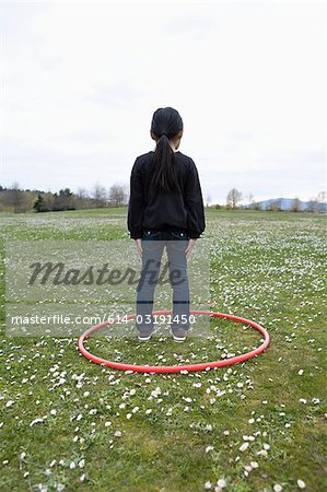 Girl standing in a hoop in a field