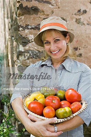 Woman with bowl of tomatoes