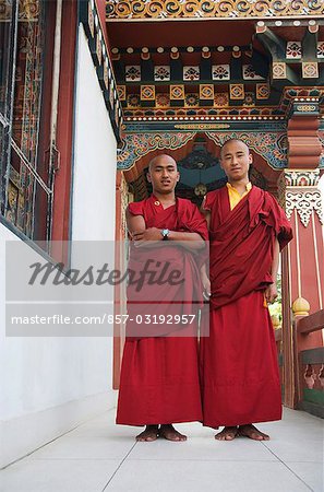 Two monks standing in the temple, Bhutan Temple, Bodhgaya, Gaya, Bihar, India