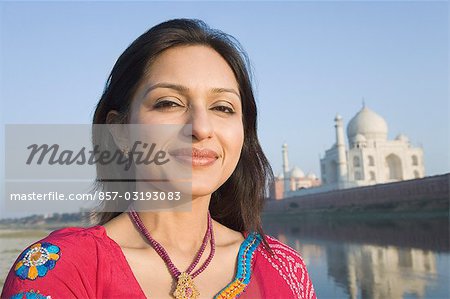 Portrait of a woman with a mausoleum in the background, Taj Mahal, Agra, Uttar Pradesh, India