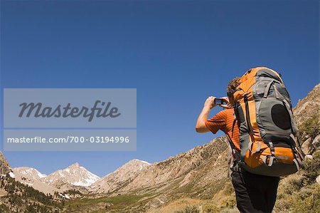 Man Taking Photograph while Backpacking, Horton Lake Trail, Inyo National Forest, California, USA Man Taking Photograph while Backpacking, Horton Lake Trail, Inyo National Forest, California, USA