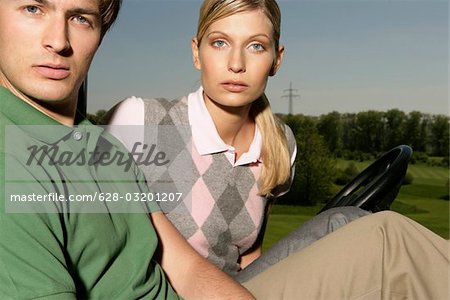 Young couple in golf cart