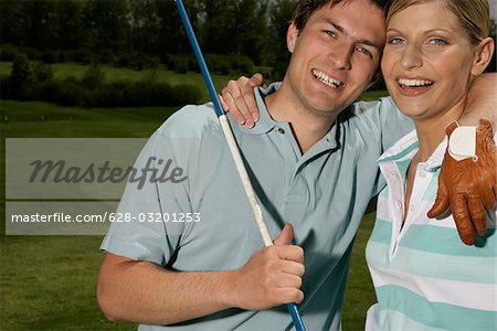 Young couple embracing on golf course