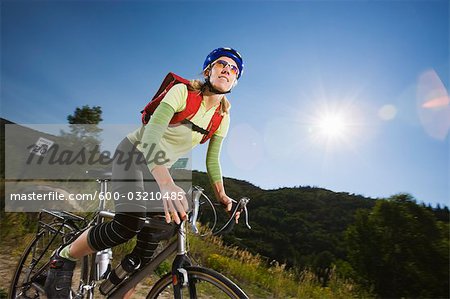 Woman Riding Bicycle, Steamboat Springs, Routt County, Colorado, USA