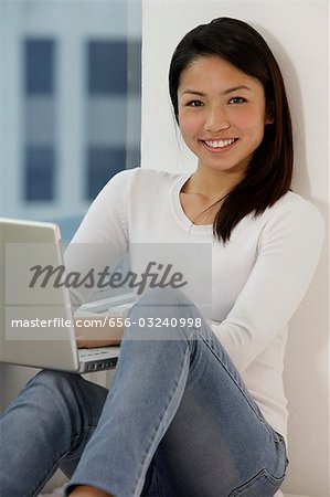 Young Asian woman working on laptop