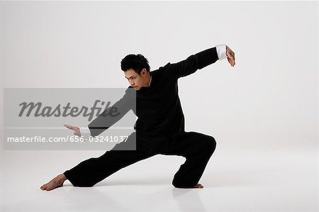 Man doing Tai Chi wearing traditional Chinese clothes