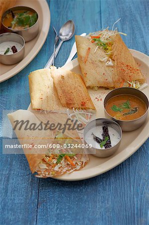 Dosa Filled With Curried Potato, Coconut Chutney, and Sambhar