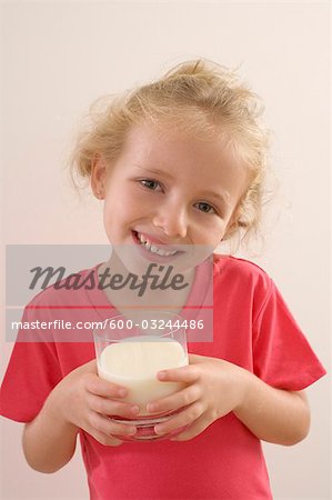 Little Girl Drinking a Glass of Milk