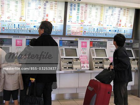 People buying ticket at the ticket machines, Shinagawa station, Tokyo, Japan