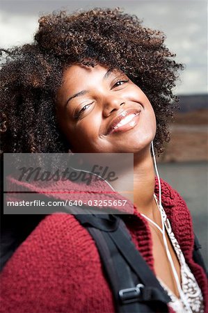 Woman with backpack and earbuds