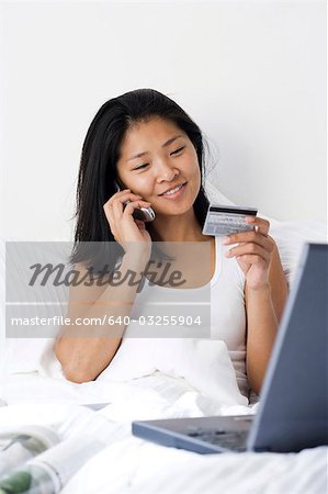 Woman working from bed