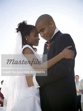 Profile of a newlywed couple embracing each other