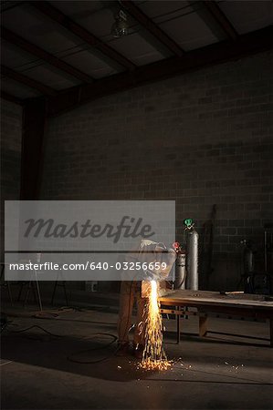 USA, Utah, Orem, man welding metal in workshop