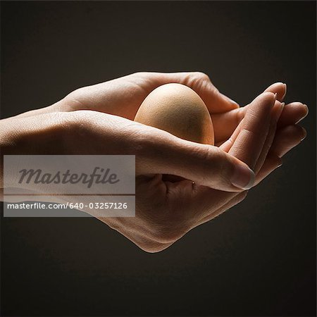 Egg in young woman's hands