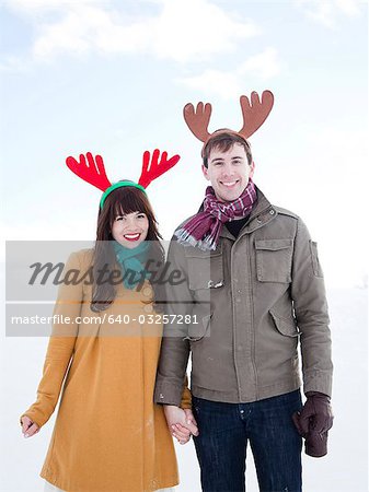 USA, Utah, Orem, young couple wearing reindeer horns, portrait