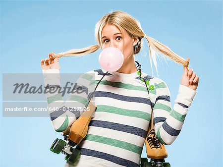 Studio portrait of young woman with roller skates