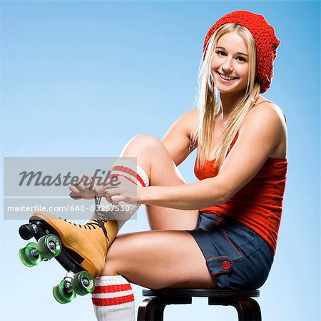 Portrait of young woman wearing roller skates