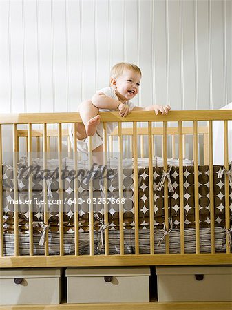 USA, Utah, Provo, baby boy (18-23 months) standing in crib