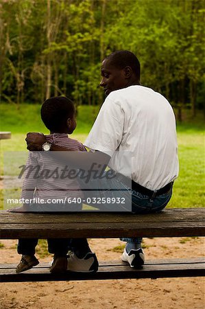 Father and son near the woods