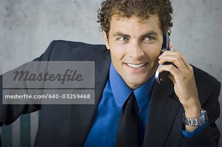 Businessman on cellular sitting on bench