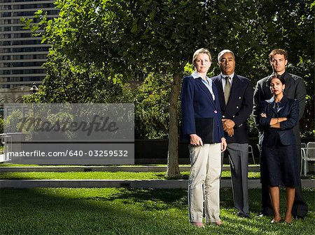 Four businesspeople standing on a lawn