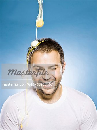 man getting an egg dropped on his head