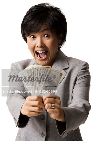 Portrait of woman holding US banknotes
