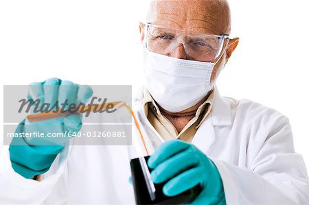 Closeup of scientist pouring chemicals into beaker