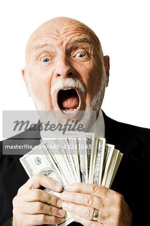 Portrait of businessman holding US banknotes