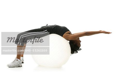 Woman stretching on pilates ball