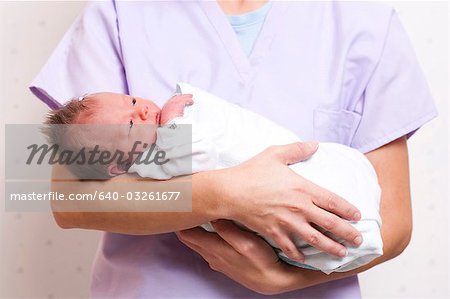 Nurse holding newborn baby