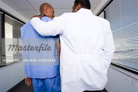 Male doctor and hospital worker talking