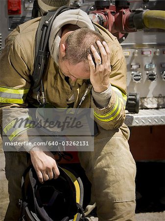 Fire fighter in uniform scratching his head