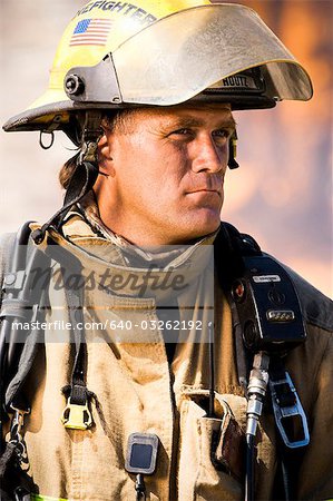 Portrait of a firefighter with fire in background