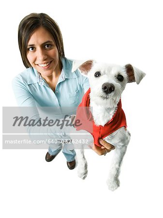 Woman with white dog in hooded sweatshirt