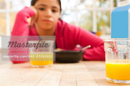 Girl sulking at breakfast table