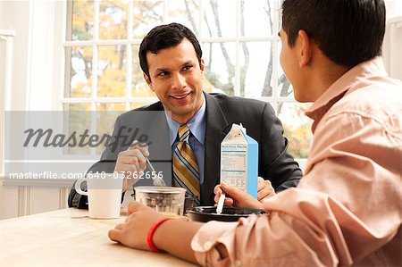 Man and boy at breakfast table displeased