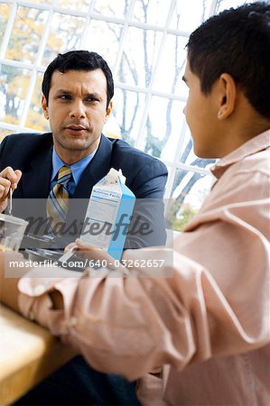 Man and boy at breakfast table smiling