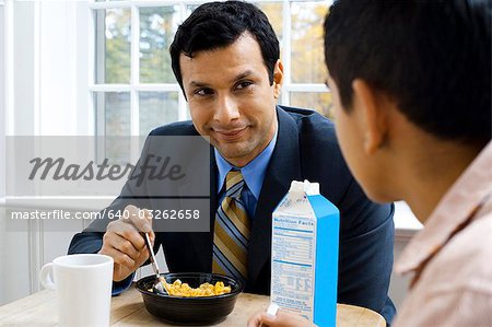Mann und Knabe am Frühstück Tisch lächelnd