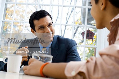 Man and boy at breakfast table smiling