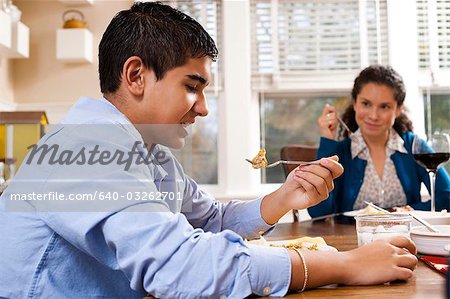 Boy eating green beans