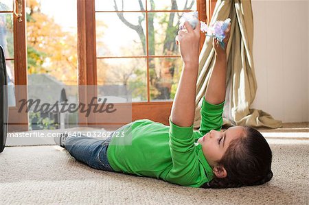 Young girl playing with toys on carpet