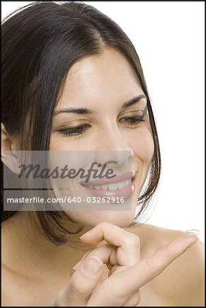Closeup of woman inserting contact lens
