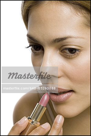 Closeup of woman applying lipstick