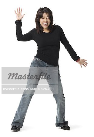 Full length woman posing in blue jeans with hands on hips