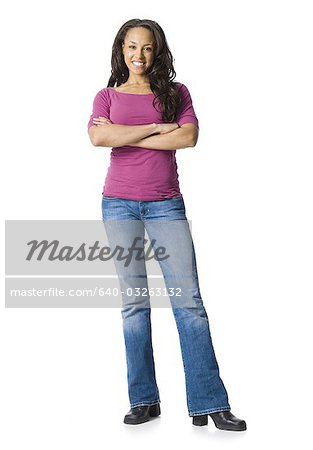 Woman in blue jeans standing with arms crossed