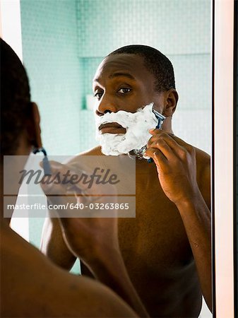 Male putting shaving cream on face