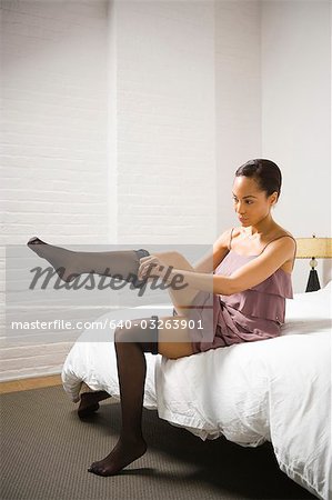 Woman putting on pantyhose