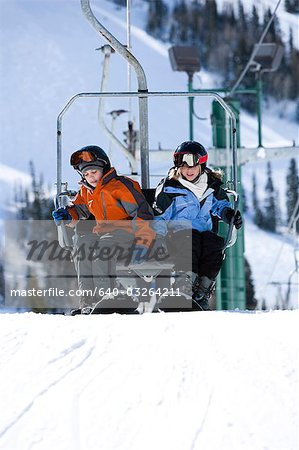 Two kids getting off a chairlift